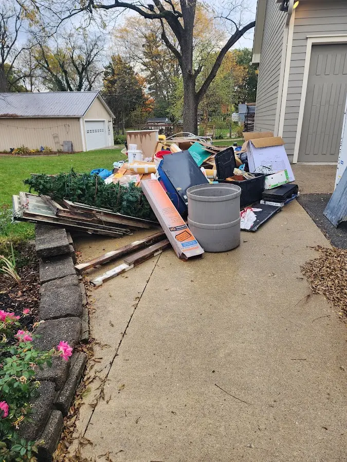 Dumpster being loaded with debris for Estate Cleanout Dumpster Rental in Rives